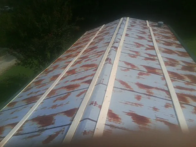 Rusted metal roof panels with new wood purlins before replacement — Storm Damage Roof Repair in Jemison by Roofing Brothers